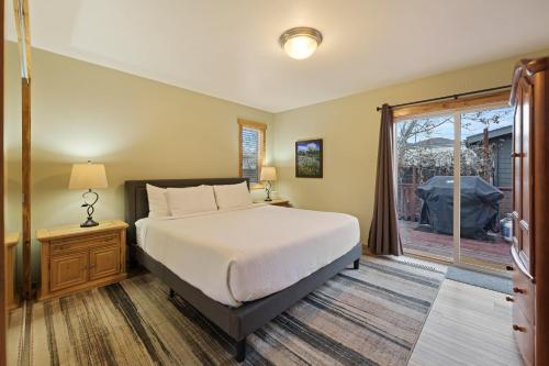 a bedroom with a large bed and a window at Huckleberry Cottage in Bend