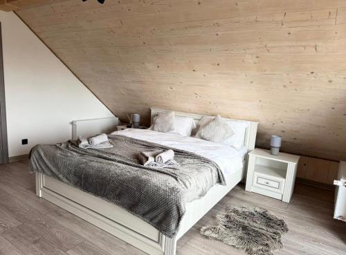 a bedroom with a bed with two dogs laying on it at LuMar Lodge Tohăniță Zarnesti in Zărneşti