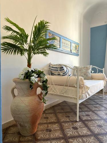 a room with a bed and a vase with a plant at Annacare in Trapani