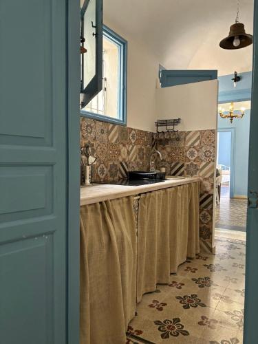 a bathroom with a long counter with a sink at Annacare in Trapani