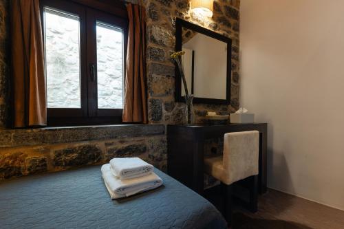 a bedroom with a bed with a mirror and a window at Voltes Mesta in Mestá