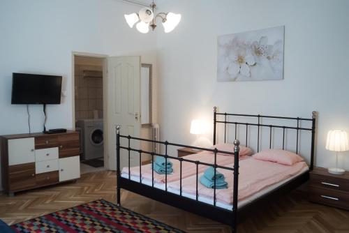 - une chambre avec un lit, une commode et une télévision dans l'établissement Friendly home in the center, à Budapest