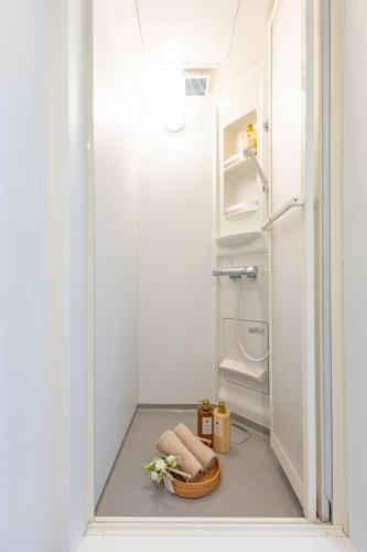 a small bathroom with a shower and a toilet at night-night 東京ドーム便利 江戸川橋駅近 池袋銀座直通 商店街徒歩圏内 in Tokyo