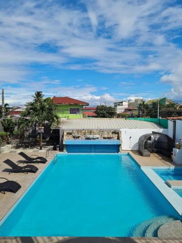 a swimming pool with blue water in a resort at Crestscente Skye Villa Resort in Pañgil