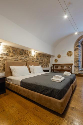 a large bed in a room with a brick wall at Voltes Mesta in Mestá