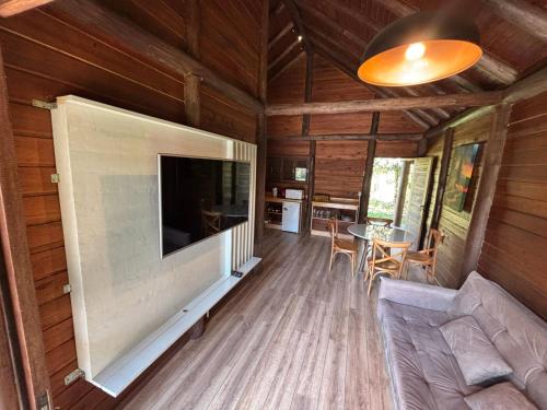a living room with a large flat screen tv at refugio in Aguas Mornas