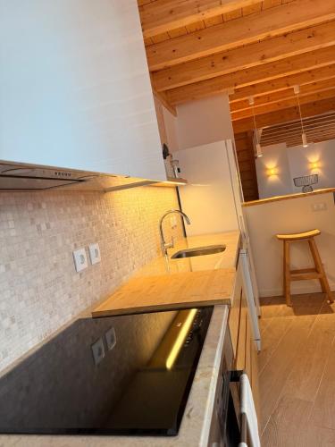 a kitchen with a sink and a counter top at Casa Da Muralha in Óbidos