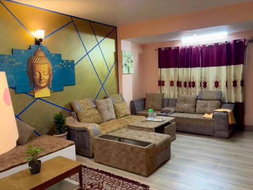 a living room with a couch and a table at Qeva Apartment I in Kathmandu
