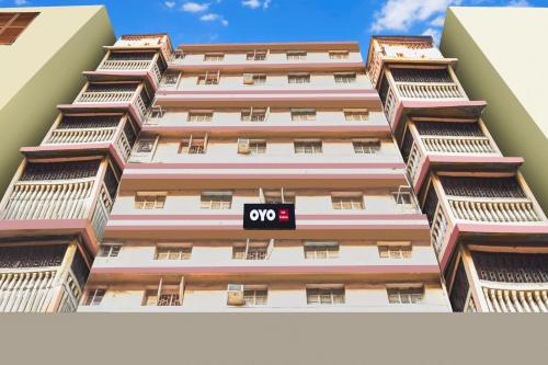 a tall apartment building with an open sign on it at Hotel O Sivalika Inn in Kolkata
