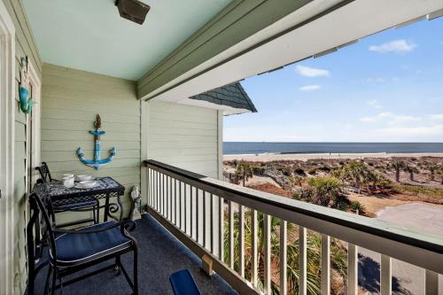 a balcony with a table and a view of the beach at SC304A: 304A Sea Cabin in Isle of Palms