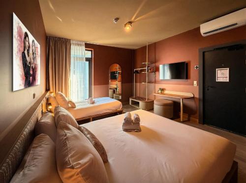 a hotel room with a couch and a bed at De Pijp Hotel in Amsterdam