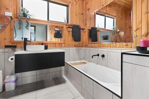a bathroom with a large tub and a sink at Air on Aldersey in McLaren Vale
