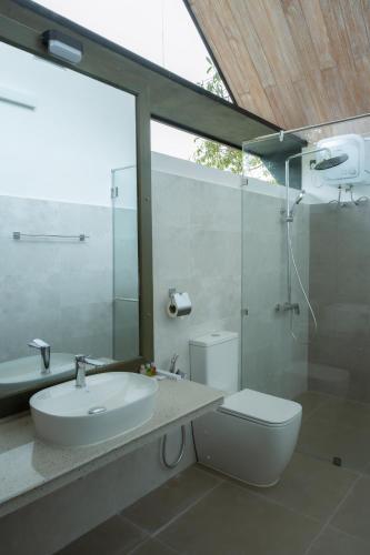a bathroom with a sink and a toilet and a shower at VerdEra Wild - Wilpattu in Wilpattu