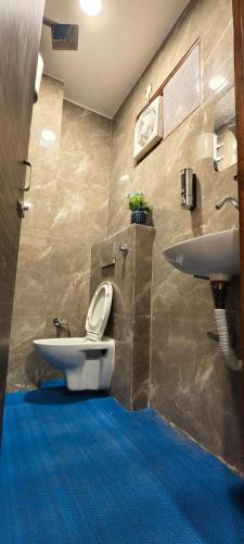 a bathroom with a toilet and a sink at Suitcase Stories Delhi in New Delhi