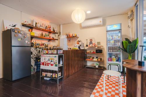 a room with a refrigerator and a shelf with food at Searyn Lanta in Ko Lanta