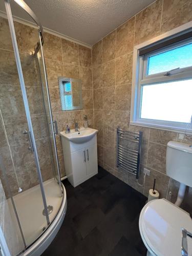 a bathroom with a shower sink and a toilet at 116, Two bed Chalet on California Sands Holiday Park - Sleeps 5, pet friendly, includes FREE pool passes, Free Entry to Clubhouse - plus Electric, WiFi, bed linen and towels all included - only 300m from the beach! in Scratby