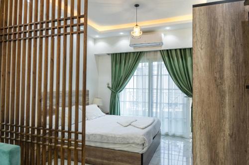 a bedroom with a bed in a wooden partition with a window at Juliana Beach Hurghada in Hurghada