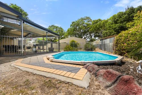 a swimming pool in a yard next to a house at Air on Aldersey in McLaren Vale