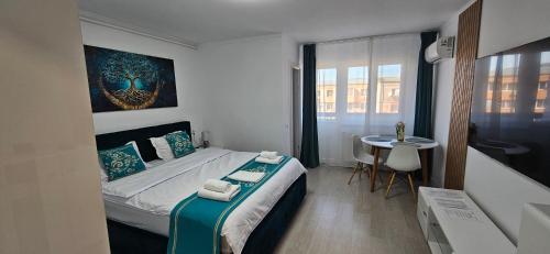 a bedroom with a bed and a table in it at Mady STUDIO in Hunedoara