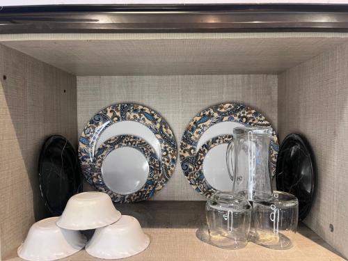 a shelf with two plates and a blender on it at Rao Studio in Noida