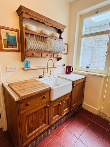 a kitchen with a sink and a window at Nethercoombe House in Portland
