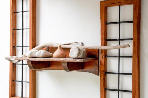 a shelf with some vases on it next to a wall at Angela studios in Troulos