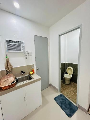 a small kitchen with a sink and a toilet at SiS B&B in San Jose