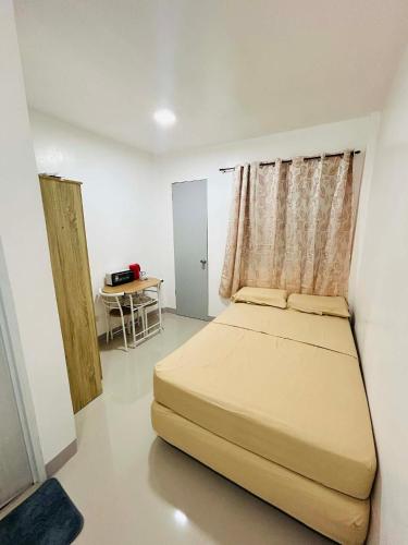 a bedroom with a bed and a table in it at SiS B&B in San Jose