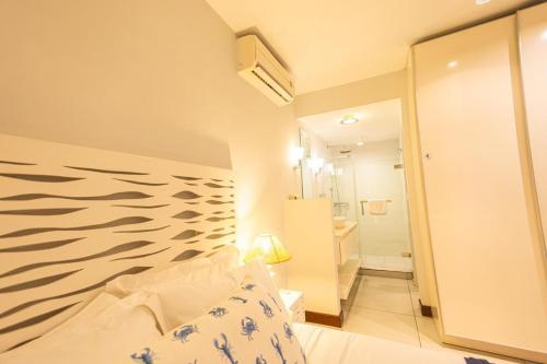a bedroom with a bed and a bathroom at Seascape Villa in Pointe aux Biches