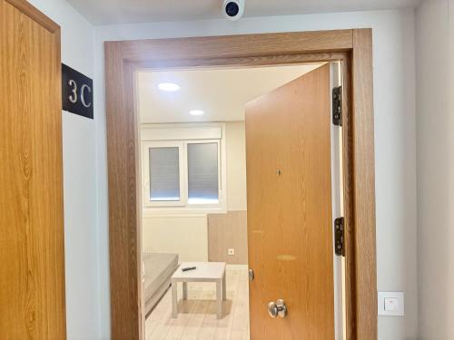 a door leading into a room with a bedroom at Apartamentos Logroño Centro in Logroño