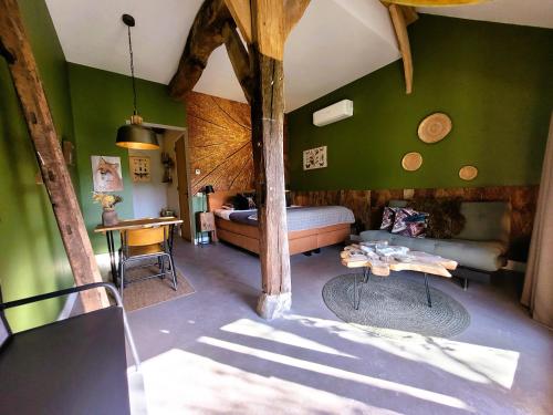 a bedroom with a bed and a table in a room at 't Buitenverblijf Erve Punte in Losser