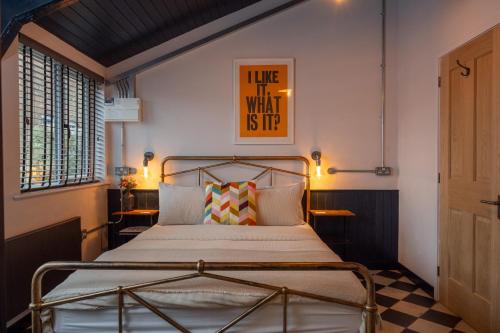a bedroom with a bed with a poster on the wall at 2 The Old Canteen, Two Minute Walk To Beach in Lyme Regis