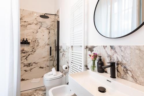 a bathroom with a white sink and a mirror at Piazza del Popolo Boutique GuestHouse in Rome