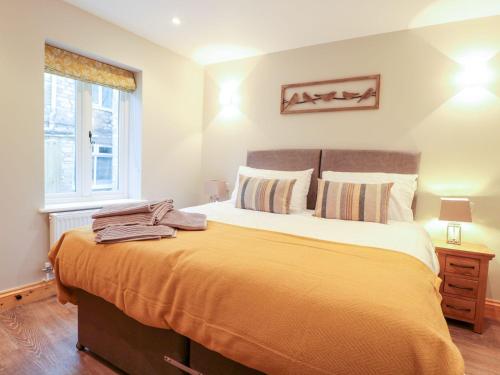 a bedroom with a large bed and a window at Old Sorting Office in Cheltenham