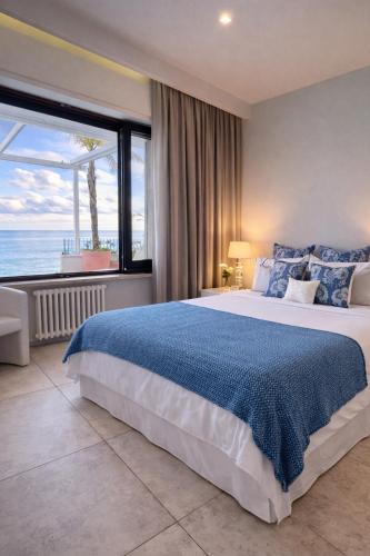 a bedroom with a large bed and a large window at MEDITERRANEAN SEASONS, VILLA MEDITERRANEA Taormina, Private Pool & Sea View in Taormina