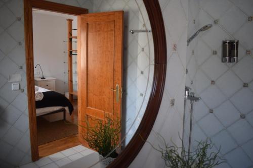 a mirror in a bathroom with a bedroom at Apartamento Belmecher in Estella