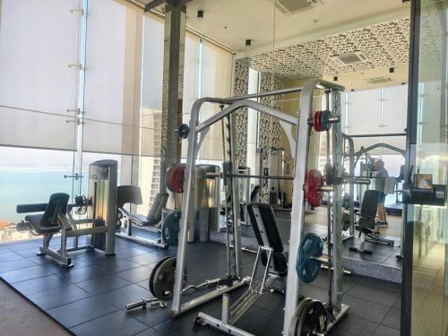 a gym with several tread machines in a room at 1 BR 5mins to beach Sea view Riviera Wongamat in North Pattaya
