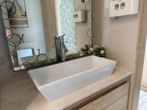 a white sink in a bathroom with a mirror at 1 BR 5mins to beach Sea view Riviera Wongamat in North Pattaya