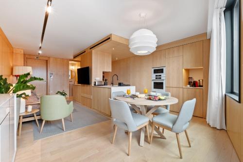 a kitchen and dining room with a table and chairs at Exclusive Terrace Apartment at Savoy Insular in Funchal