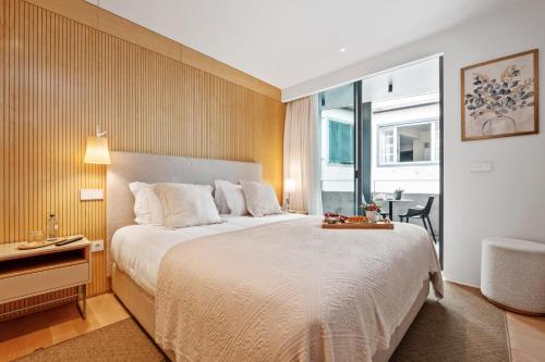 a hotel room with a large bed and a window at Exclusive Terrace Apartment at Savoy Insular in Funchal