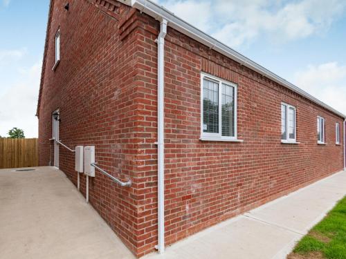 a red brick building with a window on it at Dawson Park 7 - Uk12666 in Mablethorpe