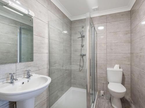 a bathroom with a toilet and a sink and a shower at Dawson Park 7 - Uk12666 in Mablethorpe