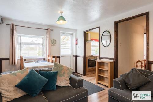 a living room with a couch and a table at Birchenfield Holiday Cottages in Dilhorne