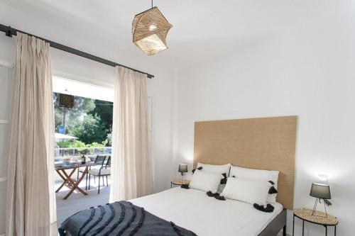 a bedroom with a large bed and a patio at Alexia Studios in Kolios
