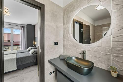 a bathroom with a sink and a bed and a mirror at Villa Delecto in Premantura