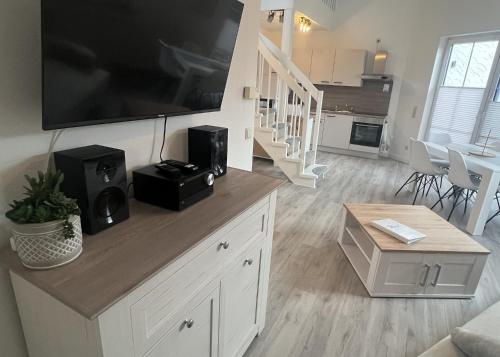 a living room with a large flat screen tv at LT35a Haus Sternengucker in Dorum-Neufeld