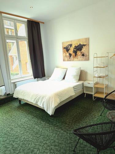 a bedroom with a bed and a large window at Hotel Colonnaden by O&N in Hamburg