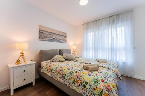 a bedroom with a bed and a window at Flex SelfCheckIns 99 - 2 Bedrooms - Parking - Loggia in Velika Mlaka