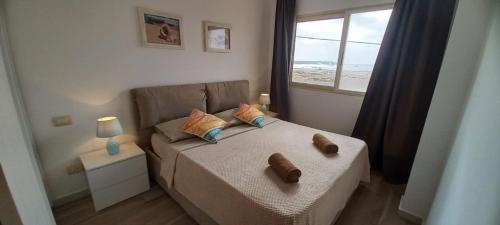 una piccola camera da letto con un letto e una finestra di Onda do Mar a Sal Rei