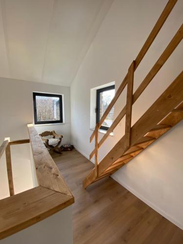 a staircase in a house with two windows at La maison d'à côté - Sart in Jalhay